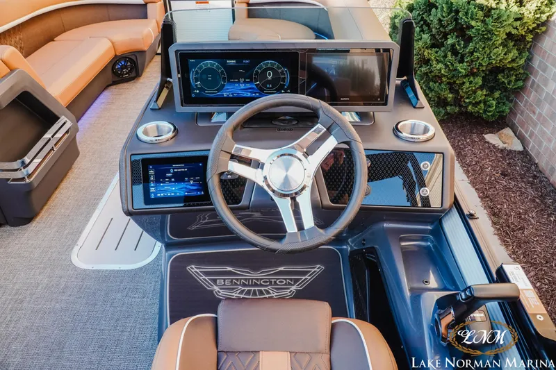 Slide: The Image of 2025 Bennington 24MFB boat dashboard with modern steering wheel and digital displays at Lake Norman Marina. - 8