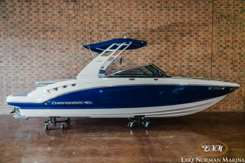 Slide: The Image of 2018 Chaparral 227 SSX boat with blue and white design at Lake Norman Marina. - 1