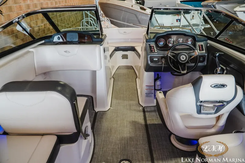 Slide: The Image of 2018 Chaparral 227 SSX boat interior with steering wheel and seating at Lake Norman Marina. - 7