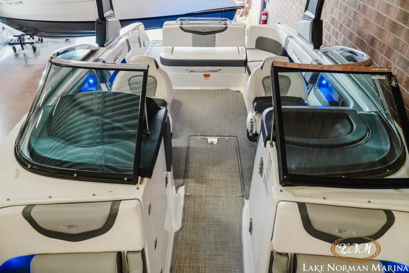 Slide: The Image of 2018 Chaparral 267 SSX boat interior with seating and blue accent lighting at Lake Norman Marina. - 19