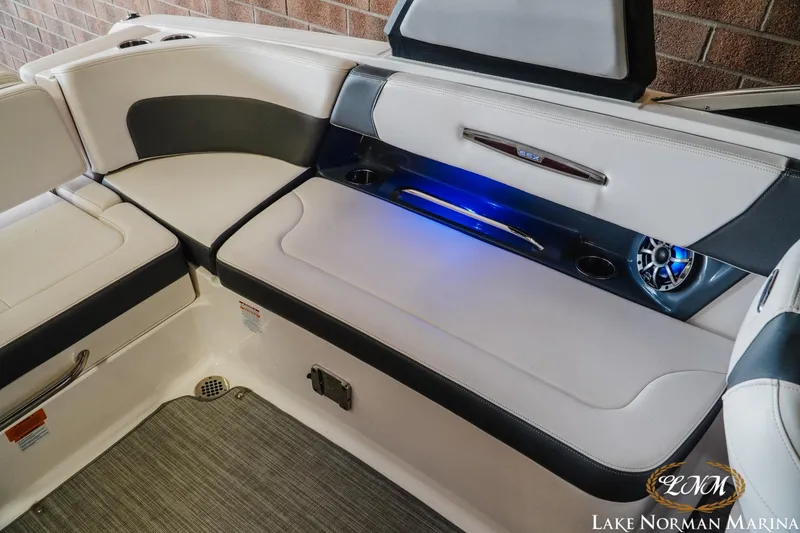 Slide: The Image of 2018 Chaparral 267 SSX boat interior with cushioned seating and blue LED lighting. - 22