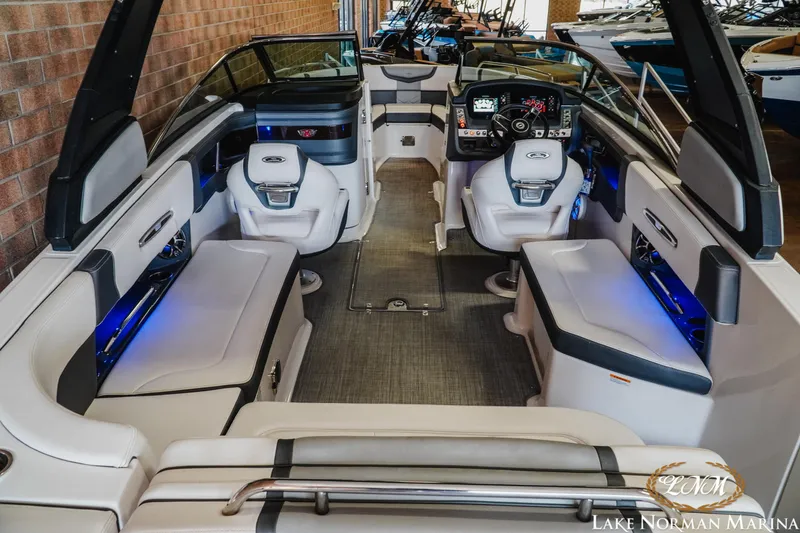 Slide: The Image of 2018 Chaparral 267 SSX boat interior with luxurious seating and modern dashboard at Lake Norman Marina. - 9