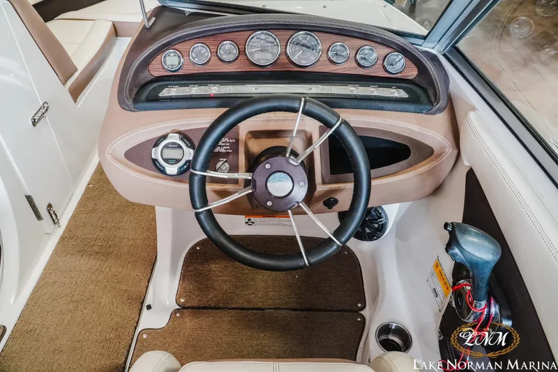 Slide: The Image of 2015 Cobalt 210 boat dashboard with steering wheel and control panel at Lake Norman Marina. - 10