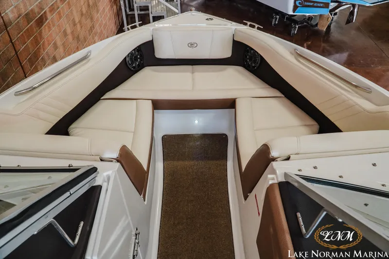 Slide: The Image of 2015 Cobalt 210 boat interior with beige seating at Lake Norman Marina. - 12