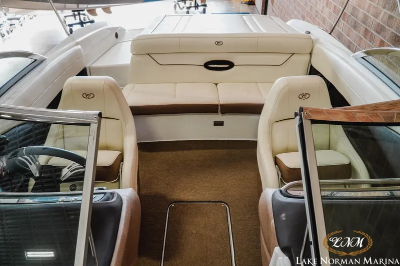 Slide: The Image of Interior of a 2015 Cobalt 210 boat with beige seating and steering wheel. - 13