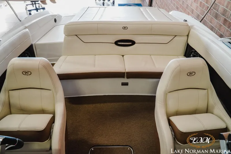 Slide: The Image of Interior of a 2015 Cobalt 210 boat with beige seating at Lake Norman Marina. - 14