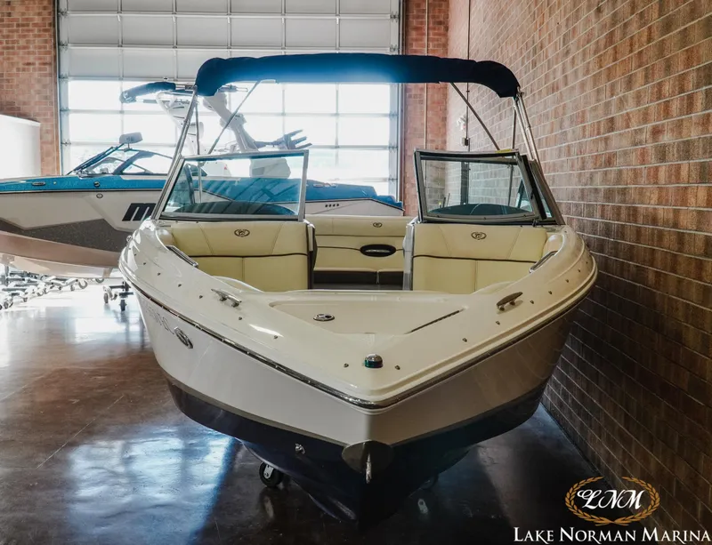 Slide: The Image of 2015 Cobalt 210 boat displayed indoors at Lake Norman Marina. - 4