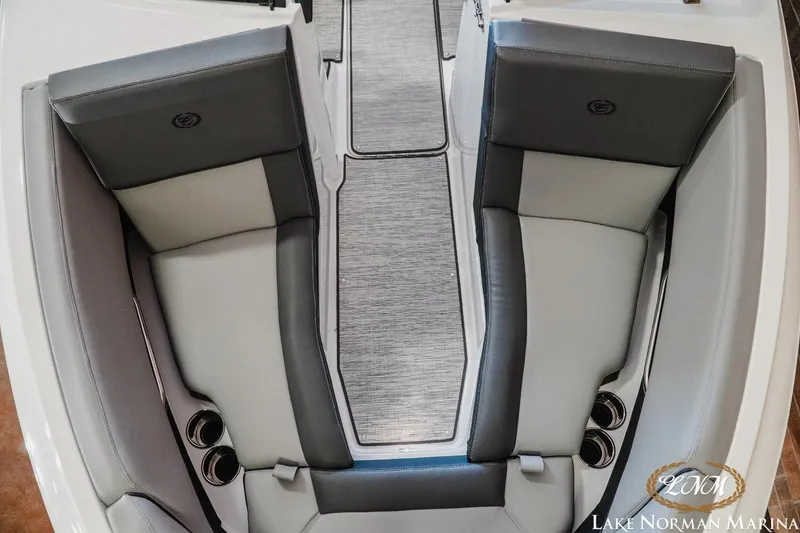 Slide: The Image of 2024 Cobalt CS22 boat interior with gray seating and cup holders at Lake Norman Marina. - 13