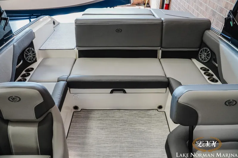Slide: The Image of 2024 Cobalt CS22 boat interior with gray seating and cup holders at Lake Norman Marina. - 16