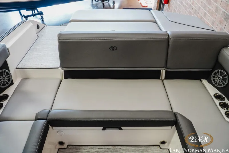 Slide: The Image of 2024 Cobalt CS22 boat interior with gray seating and cup holders at Lake Norman Marina. - 17
