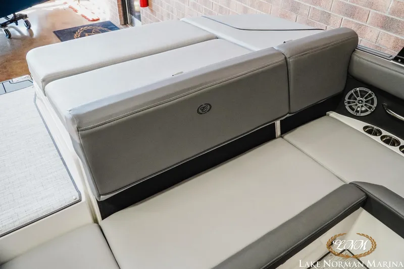 Slide: The Image of 2024 Cobalt CS22 boat interior with gray seating and cup holders at Lake Norman Marina. - 18