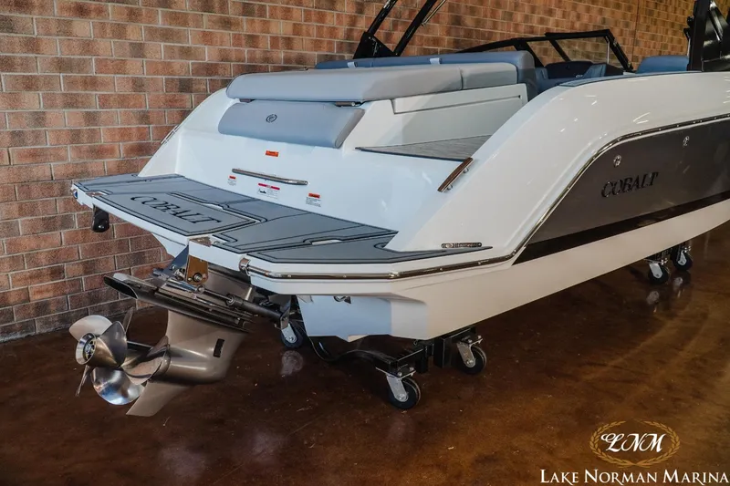 Slide: The Image of 2024 Cobalt CS22 boat rear view with propeller, displayed indoors at Lake Norman Marina. - 6