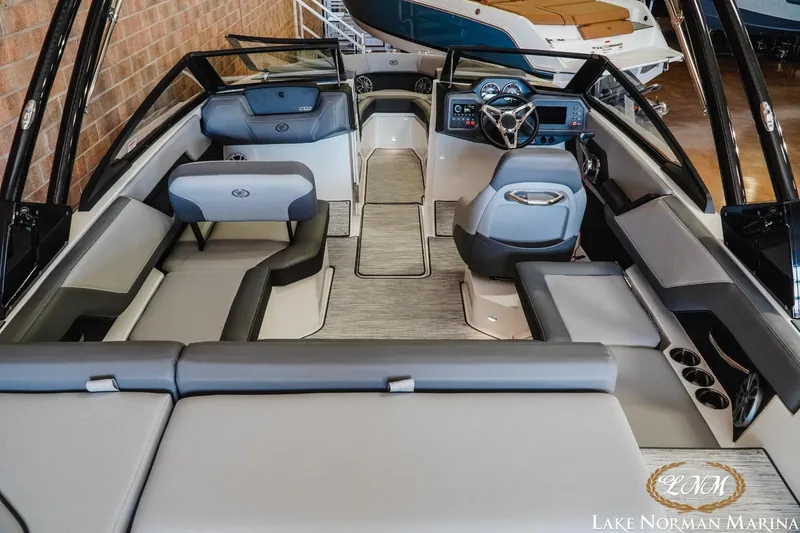 Slide: The Image of 2024 Cobalt CS22 boat interior with modern seating and steering, displayed at Lake Norman Marina. - 7