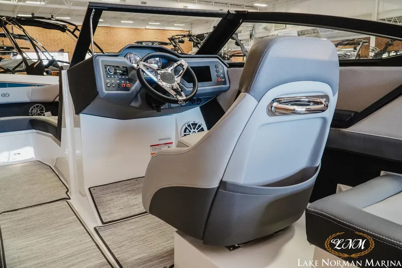 Slide: The Image of 2024 Cobalt CS22 boat interior with modern dashboard and steering wheel at Lake Norman Marina. - 9