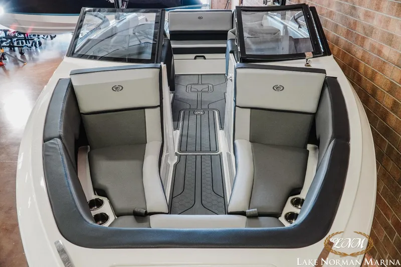 Slide: The Image of 2024 Cobalt CS23 Surf boat interior with gray seating and cup holders, displayed at Lake Norman Marina. - 12