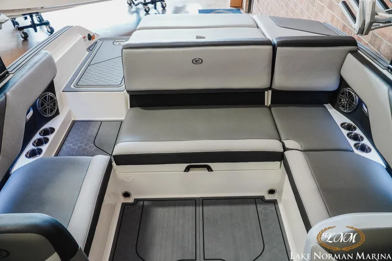 Slide: The Image of 2024 Cobalt CS23 Surf boat interior with gray seating and cup holders at Lake Norman Marina. - 17