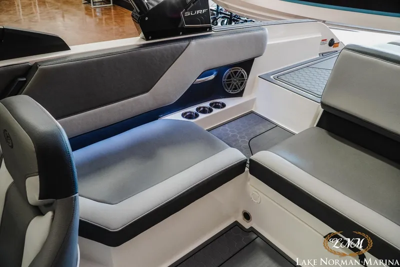 Slide: The Image of 2024 Cobalt CS23 Surf boat interior with gray seating and cup holders at Lake Norman Marina. - 18