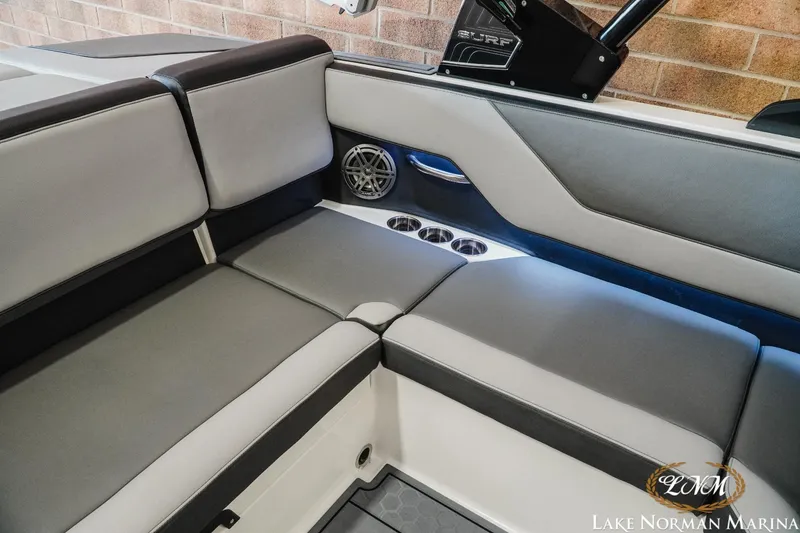 Slide: The Image of 2024 Cobalt CS23 Surf boat interior with gray seating and cup holders. - 19