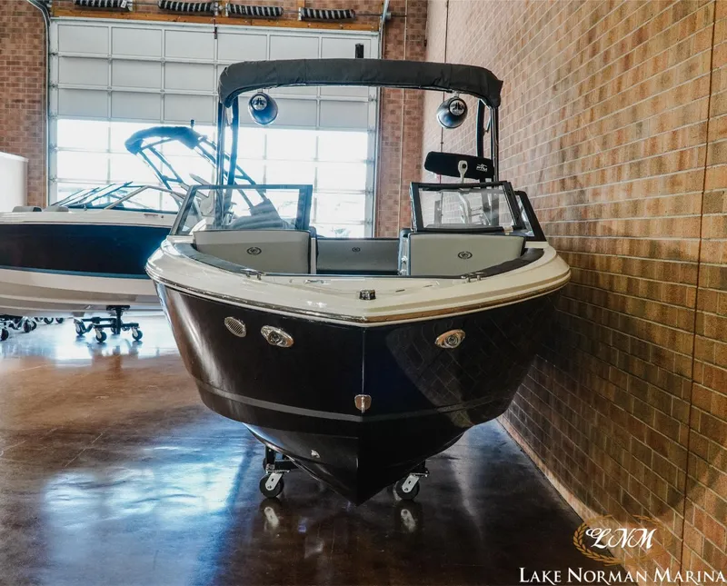 Slide: The Image of 2024 Cobalt CS23 Surf boat displayed indoors at Lake Norman Marina. - 4