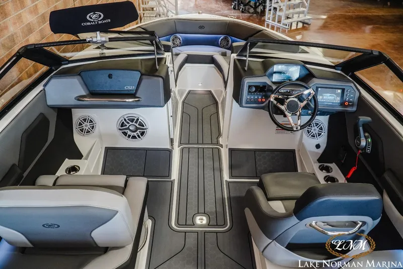 Slide: The Image of 2024 Cobalt CS23 Surf boat interior with modern dashboard and seating at Lake Norman Marina. - 8