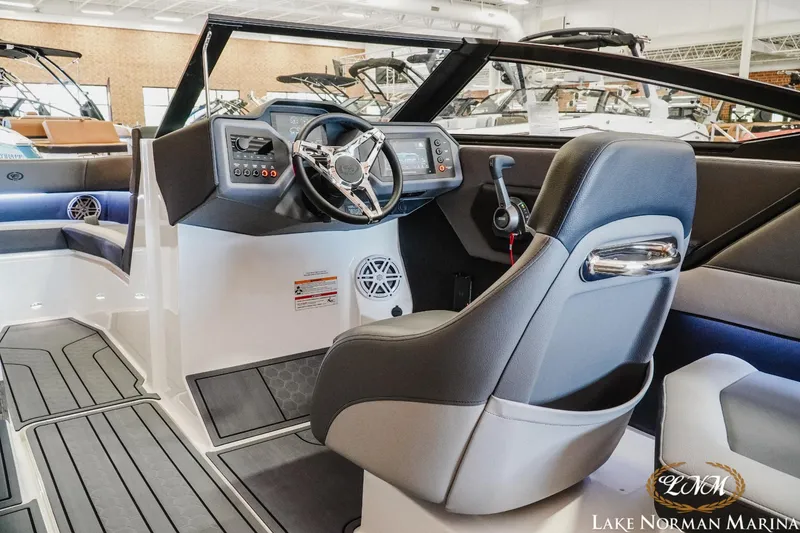 Slide: The Image of 2024 Cobalt CS23 Surf boat interior with modern dashboard and steering wheel at Lake Norman Marina. - 9