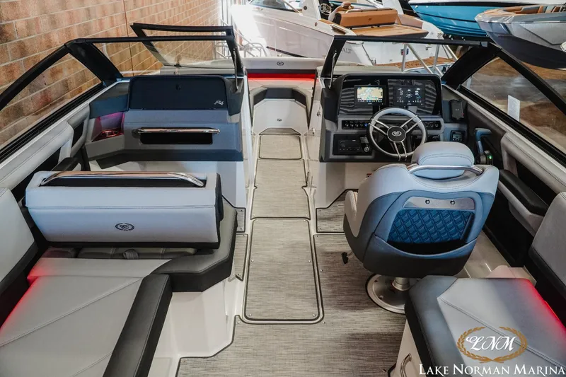 Slide: The Image of 2025 Cobalt R4 boat interior with modern dashboard and seating at Lake Norman Marina. - 8