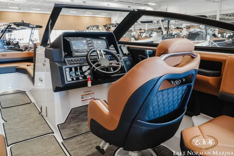 Slide: The Image of 2024 Cobalt R4 boat interior with modern dashboard and luxurious seating at Lake Norman Marina. - 11