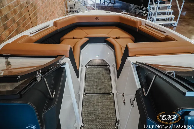 Slide: The Image of 2024 Cobalt R4 boat interior with tan seating and modern design at Lake Norman Marina. - 14