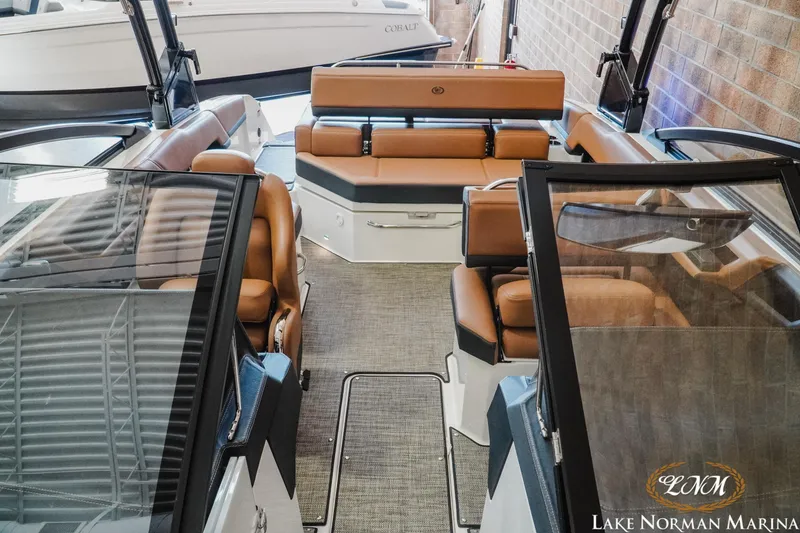Slide: The Image of 2024 Cobalt R4 boat interior with tan leather seating at Lake Norman Marina. - 15