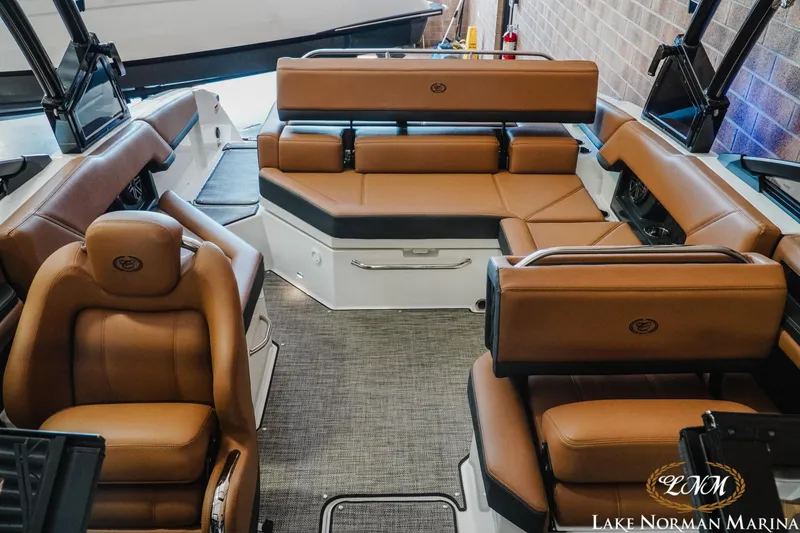 Slide: The Image of 2024 Cobalt R4 boat interior with luxurious brown leather seating at Lake Norman Marina. - 16