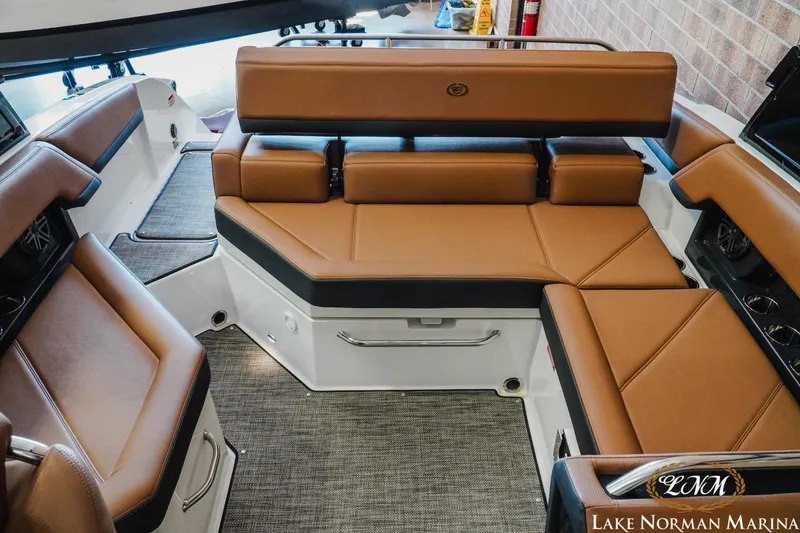 Slide: The Image of 2024 Cobalt R4 boat interior with luxurious brown seating at Lake Norman Marina. - 17