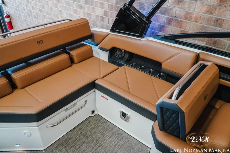 Slide: The Image of 2024 Cobalt R4 boat interior with tan leather seating and modern design. - 18