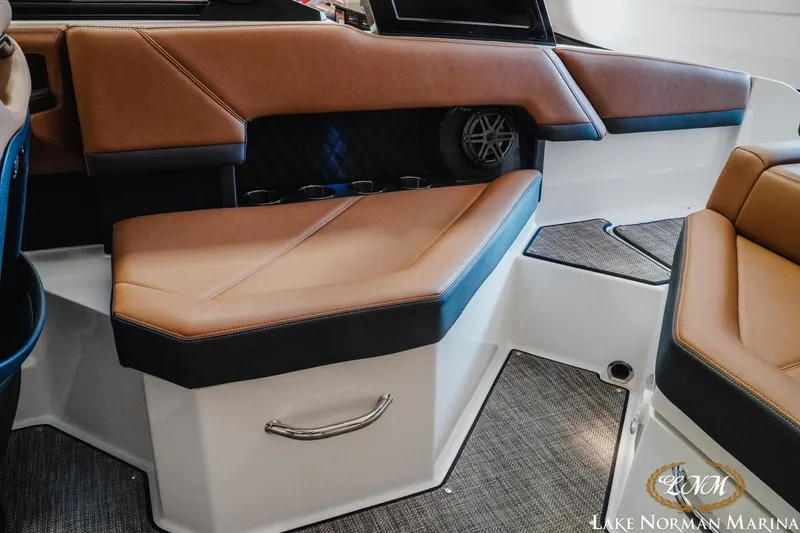 Slide: The Image of 2024 Cobalt R4 boat interior with brown leather seating and modern design. - 19