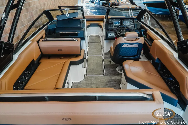 Slide: The Image of 2024 Cobalt R4 boat interior with luxurious tan seating and modern dashboard at Lake Norman Marina. - 8