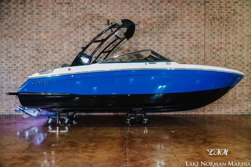 Slide: The Image of 2022 Cobalt R4 boat in blue and white at Lake Norman Marina. - 1
