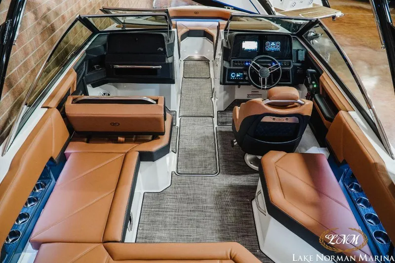 Slide: The Image of 2022 Cobalt R4 boat interior with luxurious tan seating and modern dashboard at Lake Norman Marina. - 10