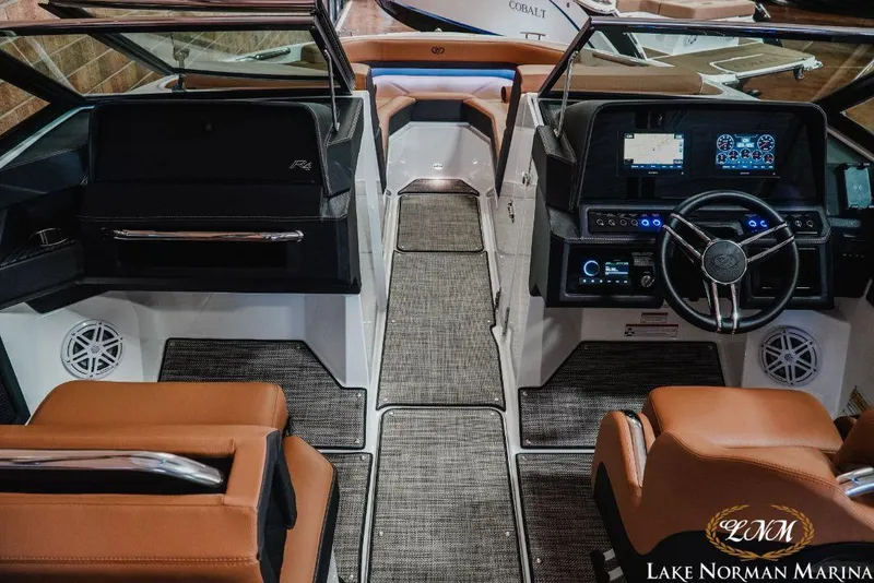 Slide: The Image of Interior of a 2022 Cobalt R4 boat with modern dashboard and leather seating. - 11