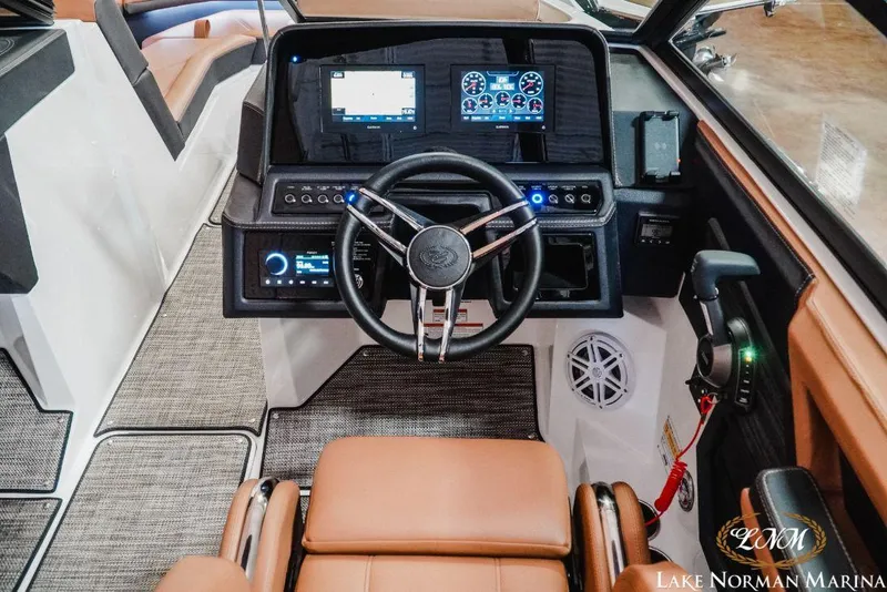 Slide: The Image of 2022 Cobalt R4 boat dashboard with steering wheel and digital displays at Lake Norman Marina. - 16