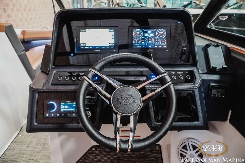 Slide: The Image of 2022 Cobalt R4 boat dashboard with steering wheel and digital displays at Lake Norman Marina. - 17