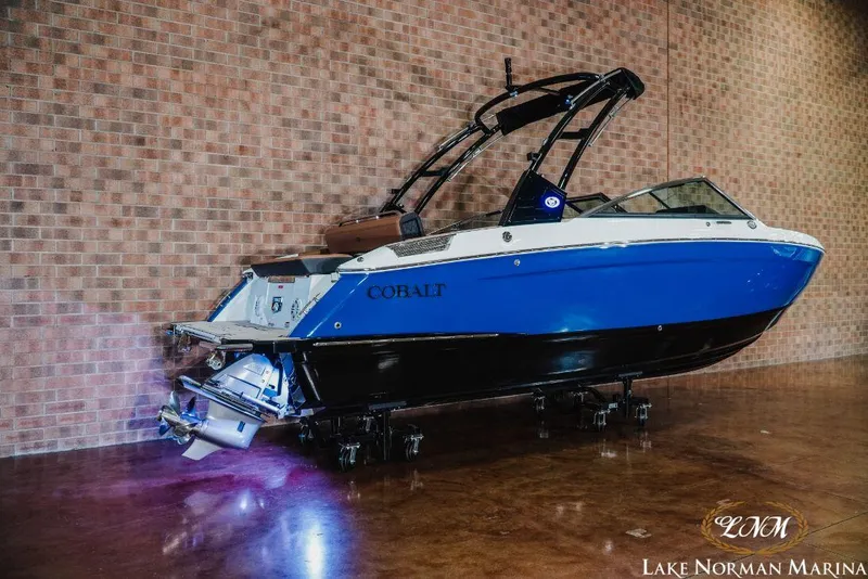 Slide: The Image of 2022 Cobalt R4 boat displayed indoors at Lake Norman Marina. - 2