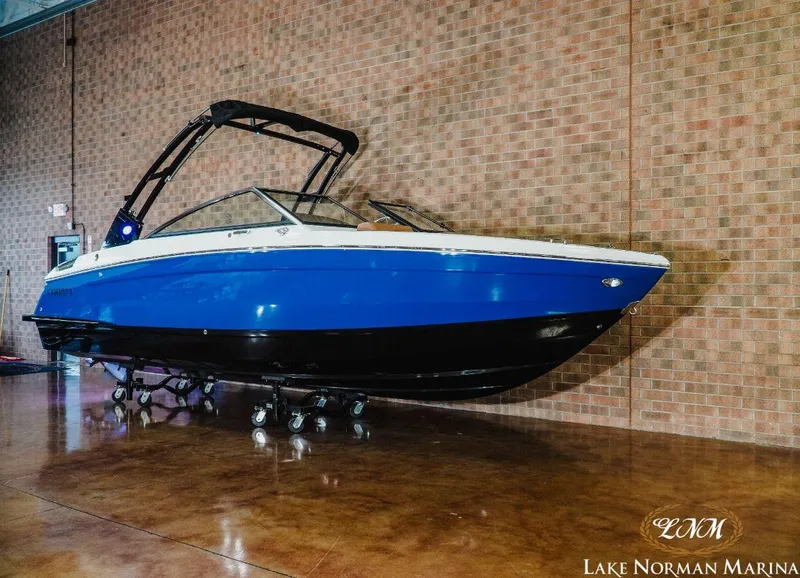 Slide: The Image of 2022 Cobalt R4 boat in blue and black, displayed indoors at Lake Norman Marina. - 3