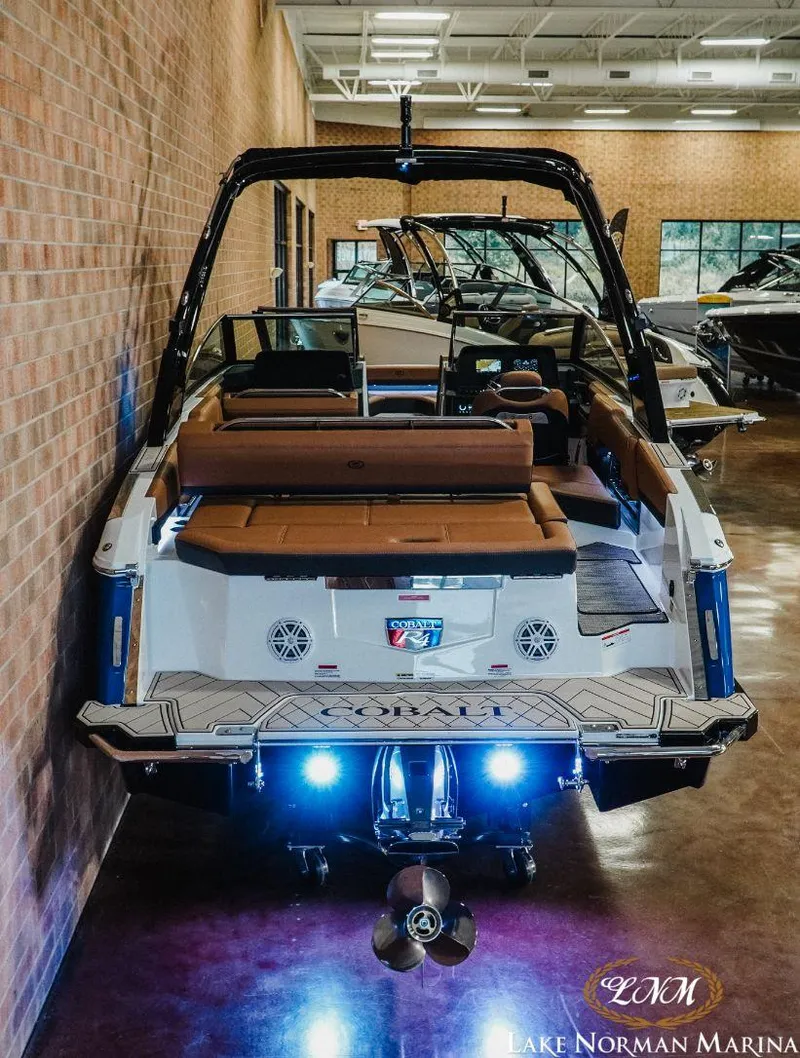Slide: The Image of 2022 Cobalt R4 boat with illuminated stern, displayed indoors at Lake Norman Marina. - 5