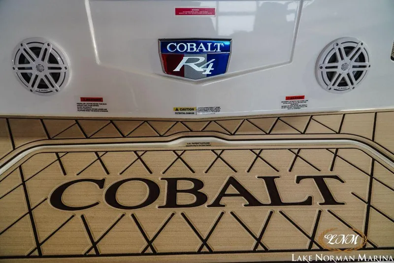 Slide: The Image of 2022 Cobalt R4 boat interior with speakers and logo at Lake Norman Marina. - 6