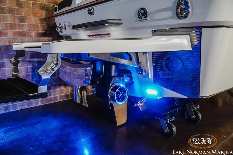 Slide: The Image of 2025 Malibu M230 boat with illuminated propeller and Surf Gate technology at Lake Norman Marina. - 29