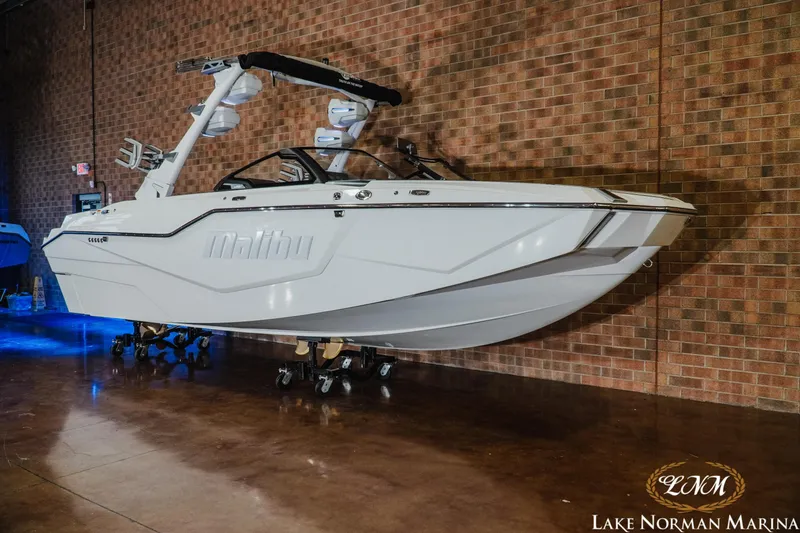 Slide: The Image of 2025 Malibu M230 boat displayed indoors at Lake Norman Marina. - 3