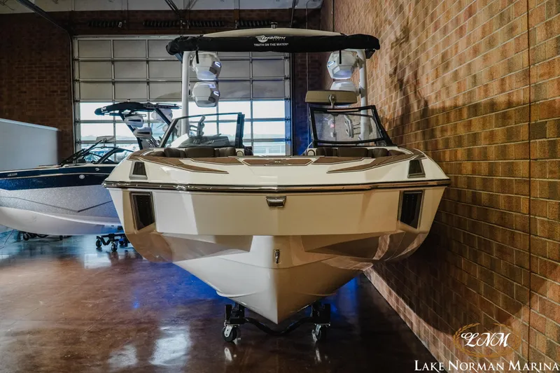 Slide: The Image of 2025 Malibu M230 boat displayed indoors at Lake Norman Marina. - 4