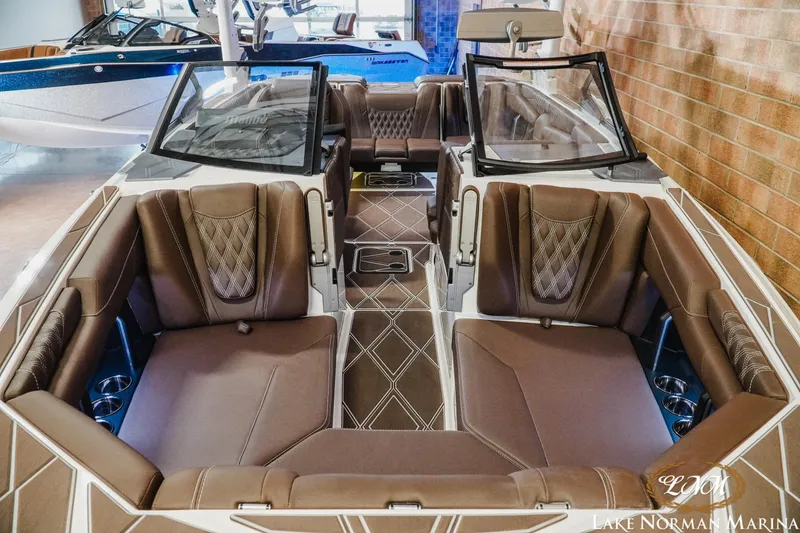 Slide: The Image of Luxurious interior of 2025 Malibu M230 boat with brown leather seating at Lake Norman Marina. - 7
