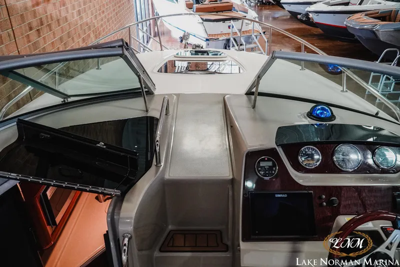 Slide: The Image of 2011 Sea Ray 280 Sundancer cockpit with dashboard and open cabin door at Lake Norman Marina. - 10