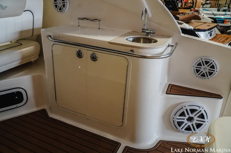 Slide: The Image of 2011 Sea Ray 280 Sundancer interior with sink, speakers, and seating at Lake Norman Marina. - 12