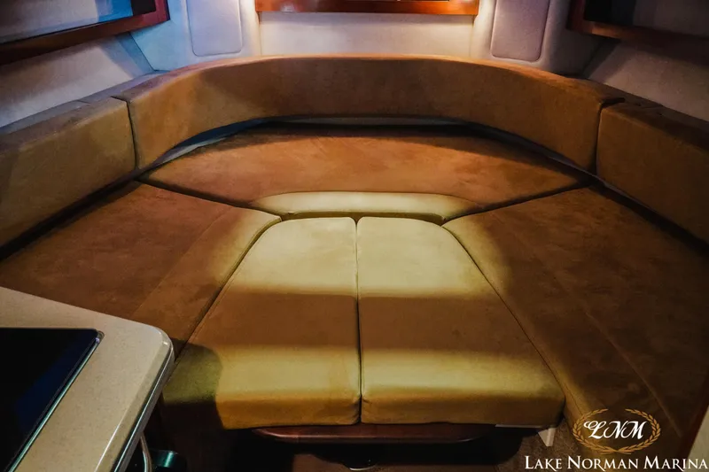 Slide: The Image of 2011 Sea Ray 280 Sundancer cabin interior with beige seating at Lake Norman Marina. - 15